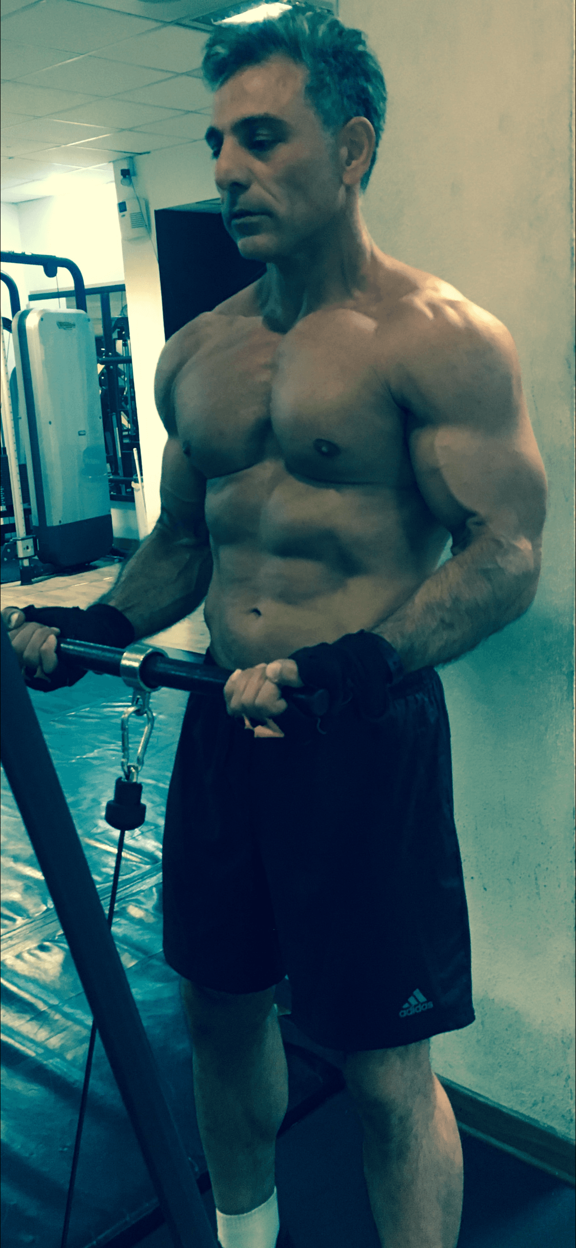 ATLAS trainer seated by dumbbells with fat loss coaching message